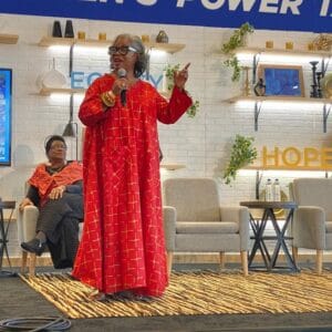 Barbara Perkins Speaking at Event | Wearing Red Gown | IBWPPI